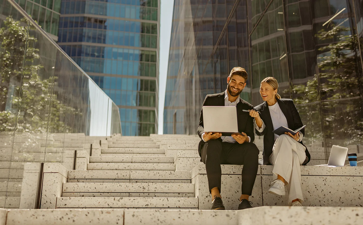 Business professionals discussing real estate management and education with city skyline background.